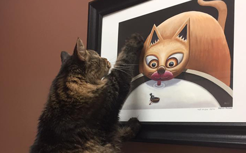 cat looking at painting